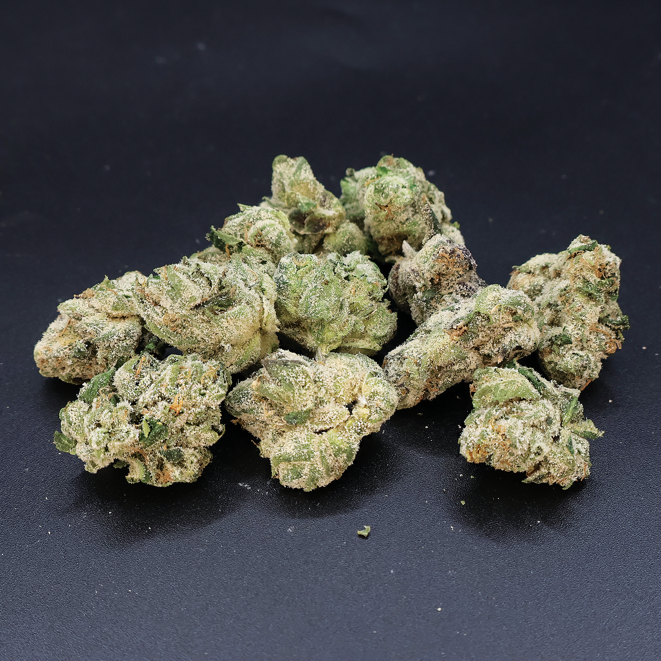 Blue Nerds THCa Flower by Miracle of the Desert, vibrant blue buds of THCA flower with leafy green accents.