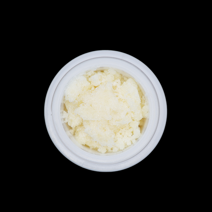 Girl Scout Cookies THCa Crumble from Miracle of The Desert, close-up of golden, textured cannabis concentrate in a jar.