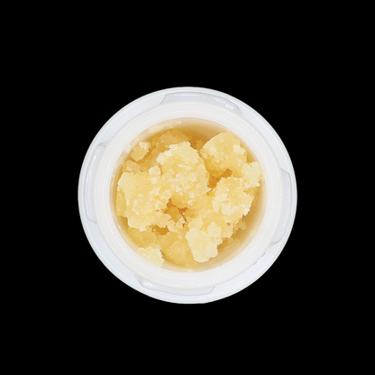 Miracle of The Desert carbon fiber THCa crumble extract in a clear container, showcasing its golden, crumbly texture.