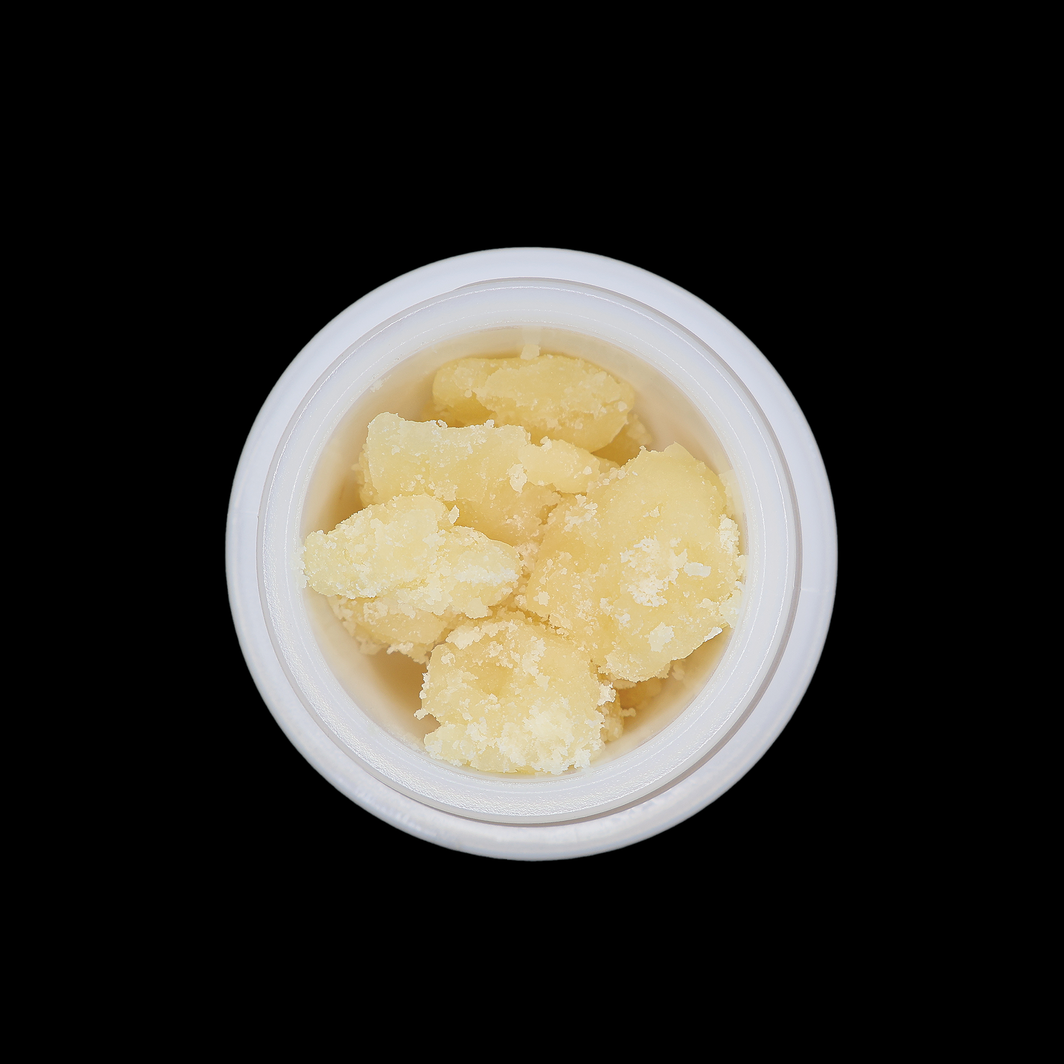 Miracle of The Desert Jealousy THCa Crumble extract in a clear container, showing golden, textured concentrate.