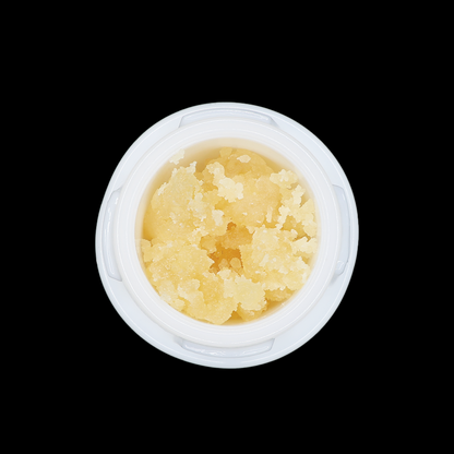 Jellie Cake THCa Crumble extract from Miracle of The Desert, showing a golden, crumbly concentrate in a clear container.