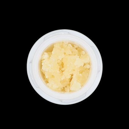Miracle of The Desert Monster Cookies THCa Crumble extract in a clear container with a textured, golden-brown crumbly appearance.