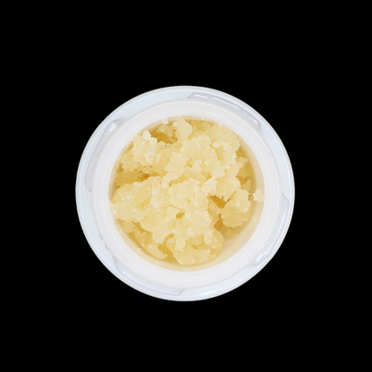 Miracle of The Desert Mule Kick THCa Crumble extract in a clear container with crumbled golden appearance.