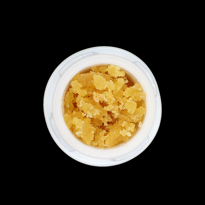 Miracle of The Desert PB Soufflé THCa Crumble extract in a clear container, showing golden, crumbly THCa concentrate.