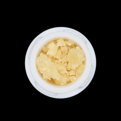 Close-up of Punch Breath THCa Crumble extract from Miracle of The Desert, showing the golden, crumbly concentrate texture.