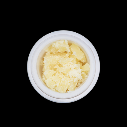 Miracle of The Desert Sangria THCa Crumble extract in a glass jar, showcasing vibrant red-orange crumble texture.