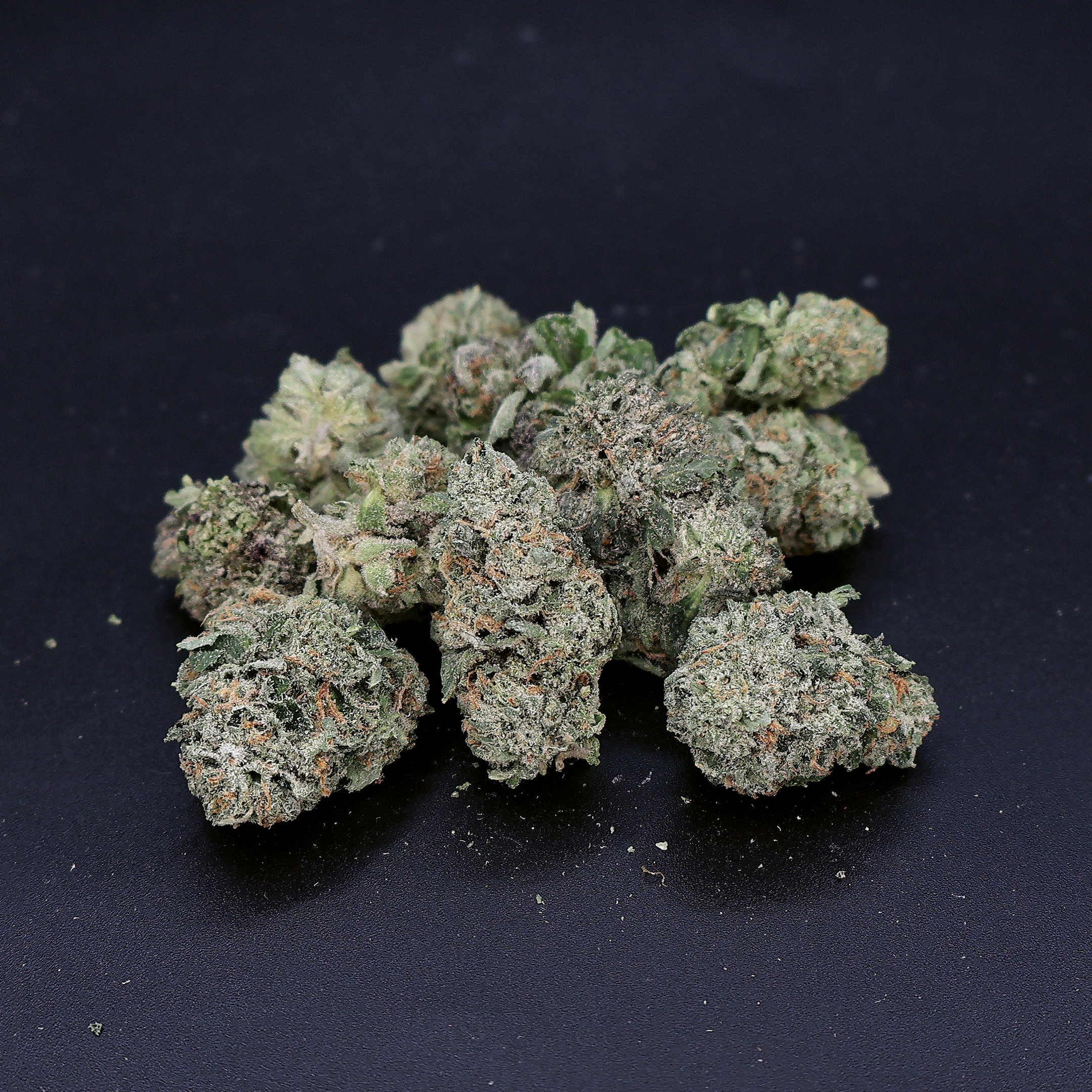 Miracle of the Desert Grape OG THCA Flower small buds with purple and green hues, showcasing dense cannabis flower.