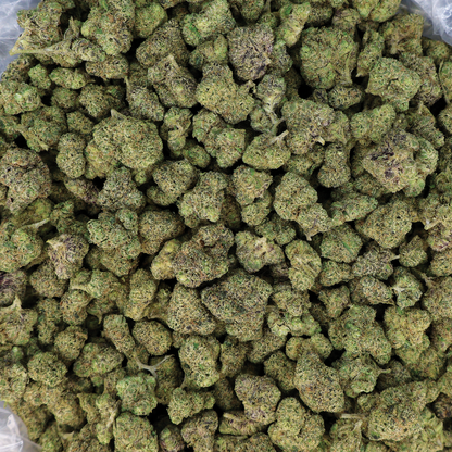 THCA flower labeled Snoop Dogg OG from Miracle of the Desert, showing small buds with green and orange hues and trichomes.